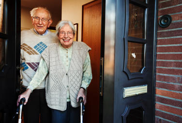 Older Couple Standing At Door